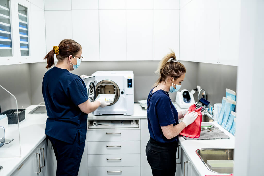 My Family Dental team members preparing instruments in the sterilisation room