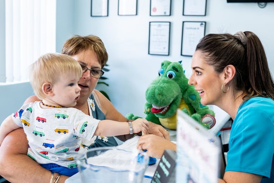 A young child at the My Family Dental reception desk