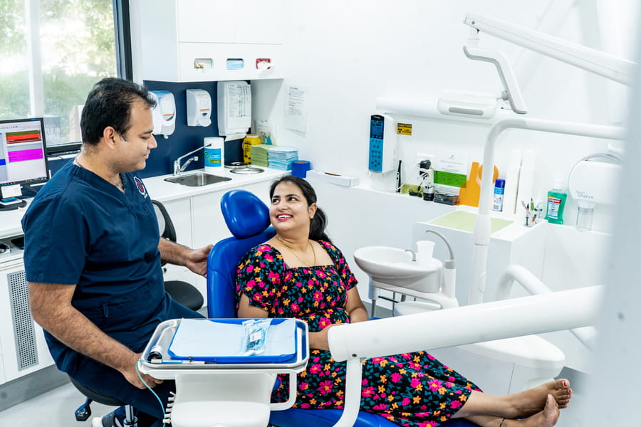A My Family Dental dentist talking with a patient in the treatment room